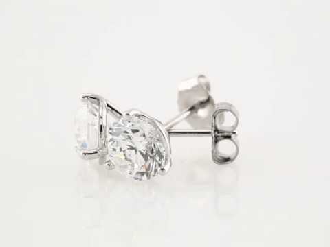 14kt white gold diamond studs earrings in a martini style setting with push backings. The two diamonds total 1 ctw and the diamonds are G-H color I1 clarity.